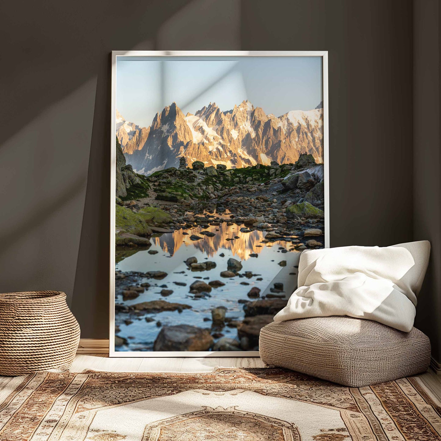 Golden sunrise lighting the reflection of Aiguille de Chamonix in a tranquil mountain puddle.