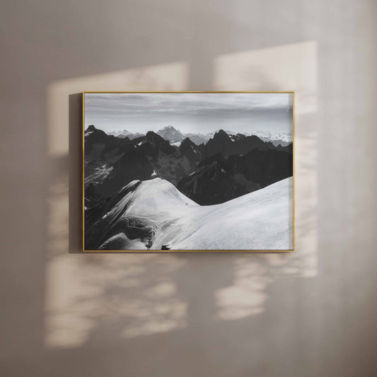 Two mountaineers setting off into Chamonix's high mountains under dramatic skies, captured as a fine art wall print.