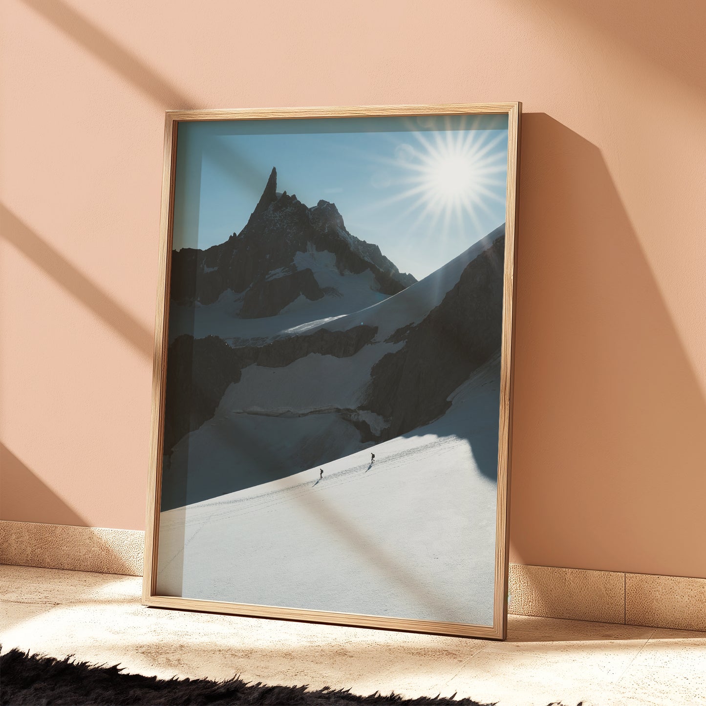 Framed mountain photography print styled in Scandinavian interior – mountaineers crossing Vallée Blanche scene