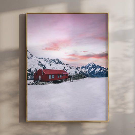 Framed Mueller Hut and Mount Cook winter photography print in gold float frame mounted on warm beige wall with window light shadows