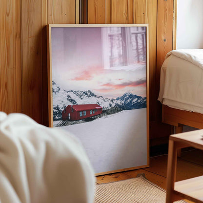Alt: Framed Mueller Hut and Mount Cook winter print in natural wood frame leaning against pine panelled bedroom wall