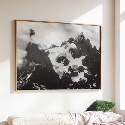 Large black-and-white framed artwork of the Needles of Chamonix in a bright living room with minimalist decor.