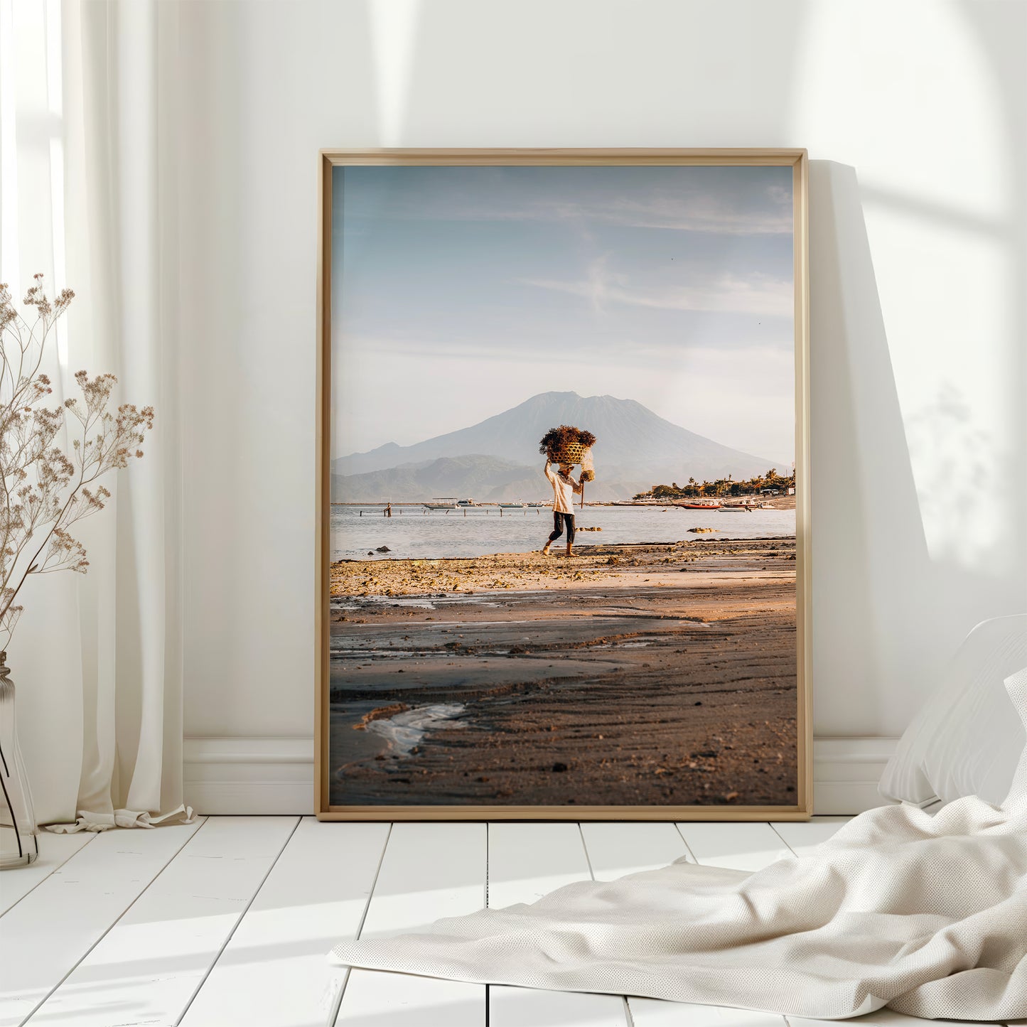 Nusa Lembongan seaweed farmer large framed wall art print in natural wood frame leaning against white wall with dried flowers