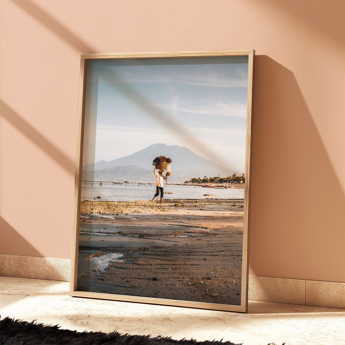 Nusa Lembongan seaweed farmer beach print with Mount Agung in natural wood frame leaning against peach terracotta wall