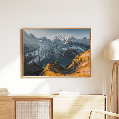 Morning view of Oeschinensee with sunlit peaks and serene waters, creating a perfect nature wall art for your home or office.