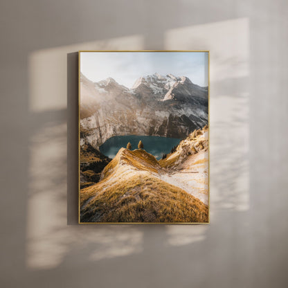 Oeschinensee lake and sunlit Swiss Alps, framed in gold, creating a warm and elegant aesthetic.