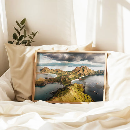 Natural wood framed Padar Island Komodo National Park Flores Indonesia aerial print leaning against pillows in a bedroom setting