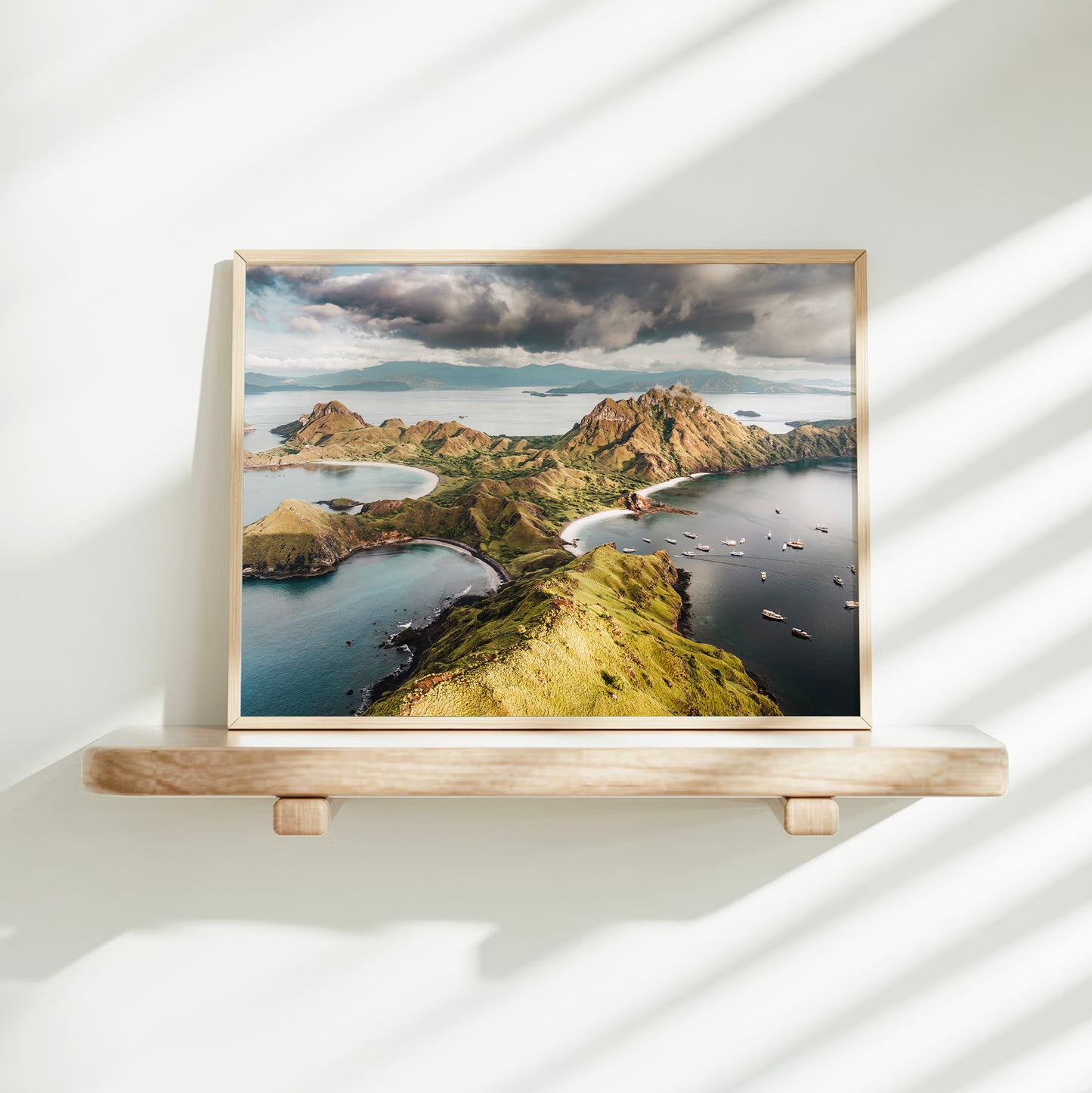 Gold framed aerial print of Padar Island Komodo National Park Flores Indonesia on a minimalist wall shelf with soft natural light