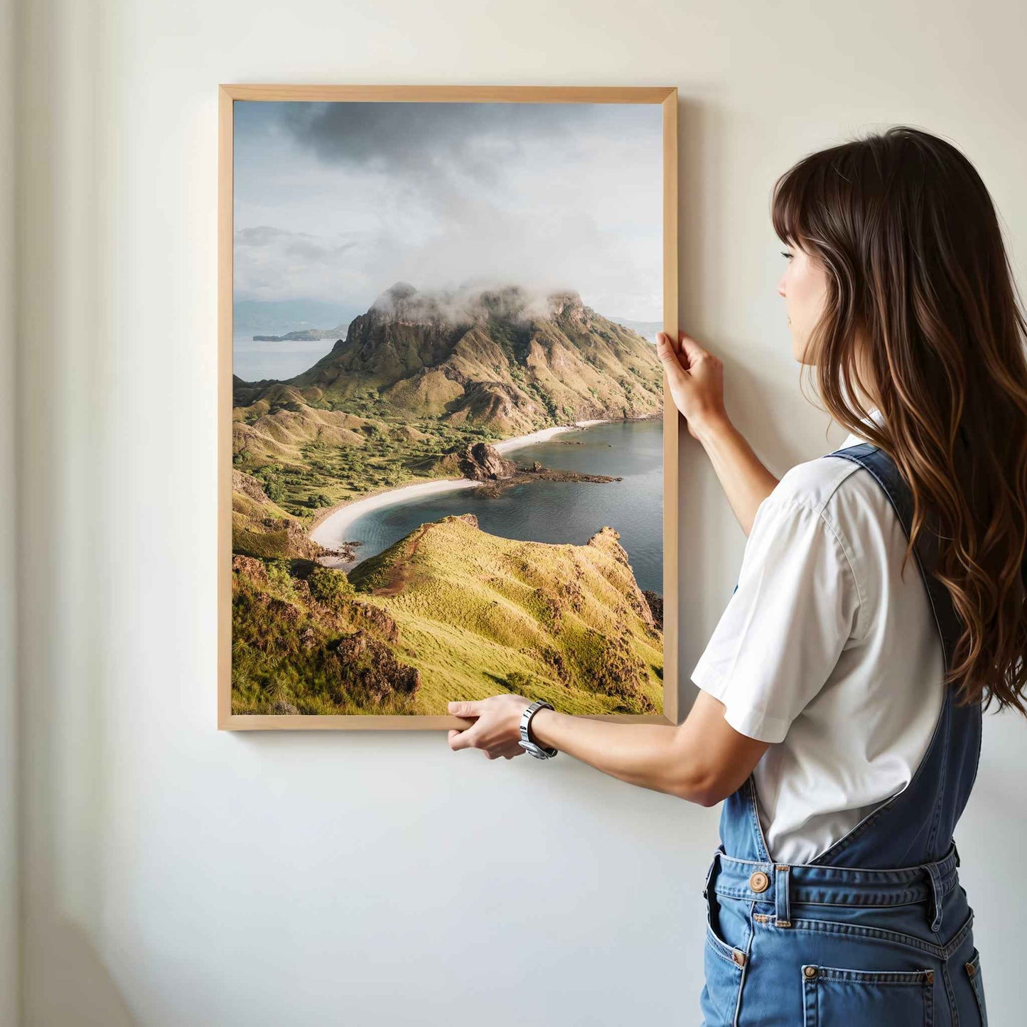 Woman hanging Padar Island Komodo National Park framed art print in natural oak wood frame on white wall