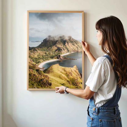 Woman hanging Padar Island Komodo National Park framed art print in natural oak wood frame on white wall