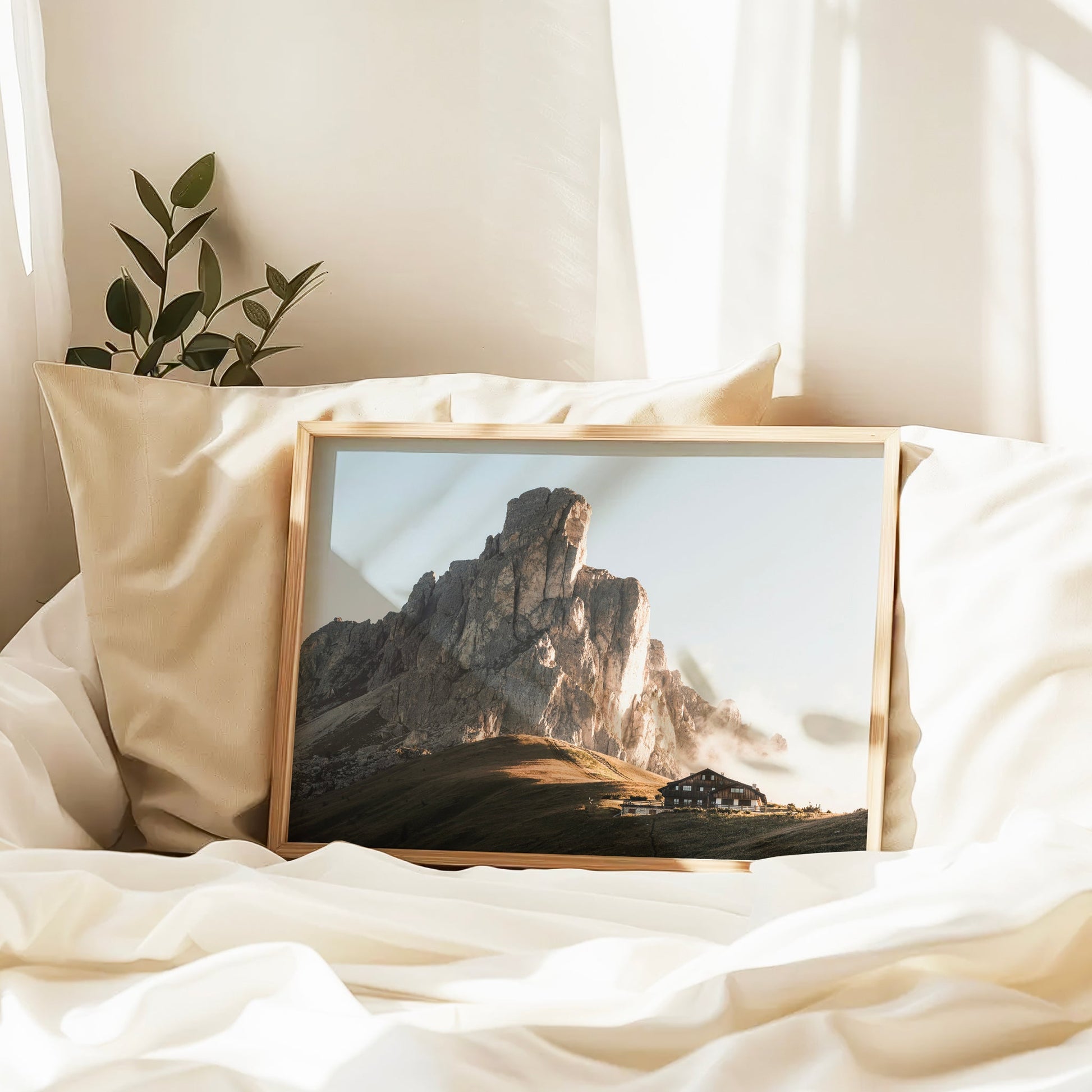 Alpine mountain print of Passo Giau displayed in a bedroom with soft sunlight