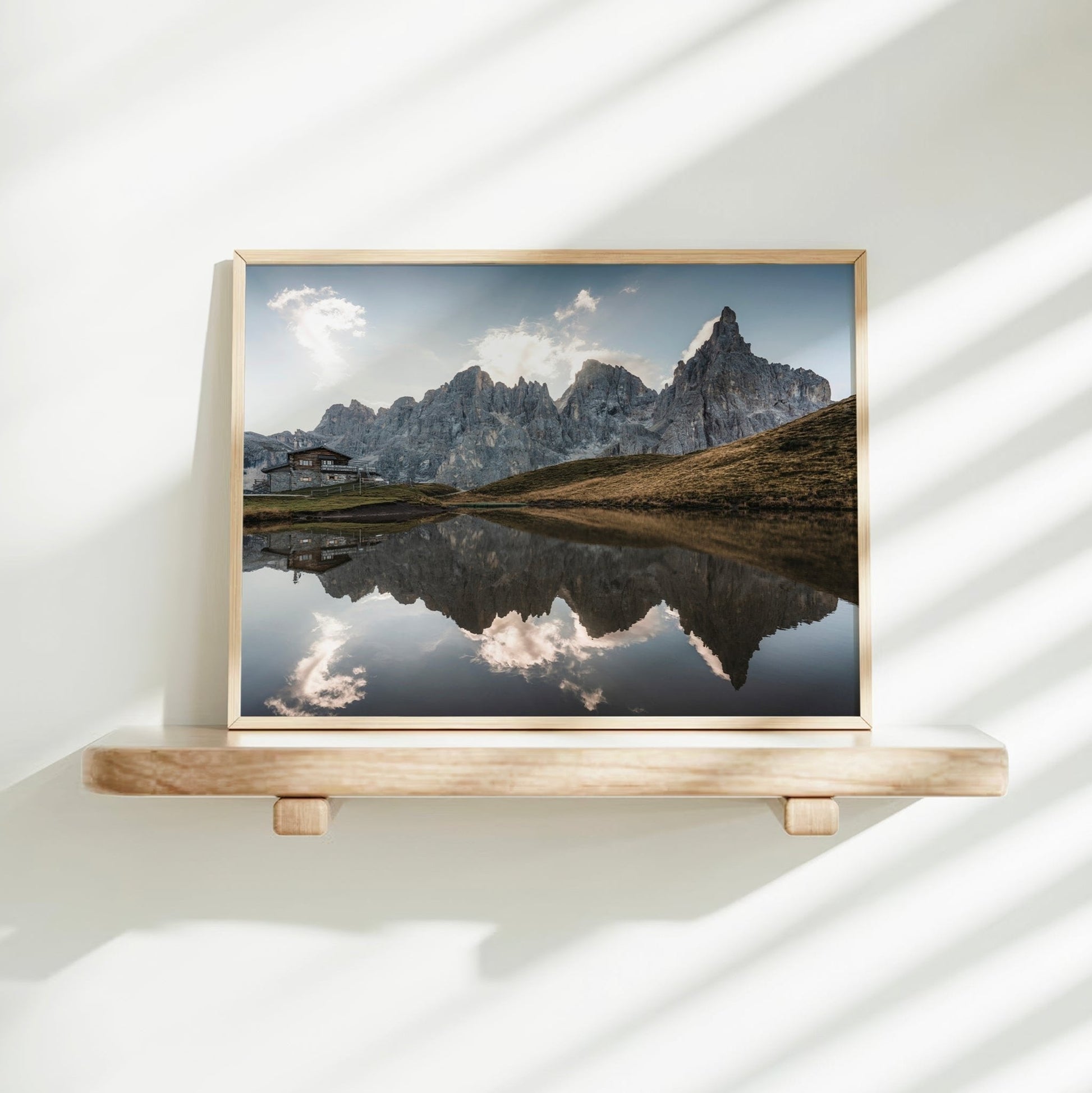 Passo Rolle Dolomites print displayed on shelf with sunlight and natural tones