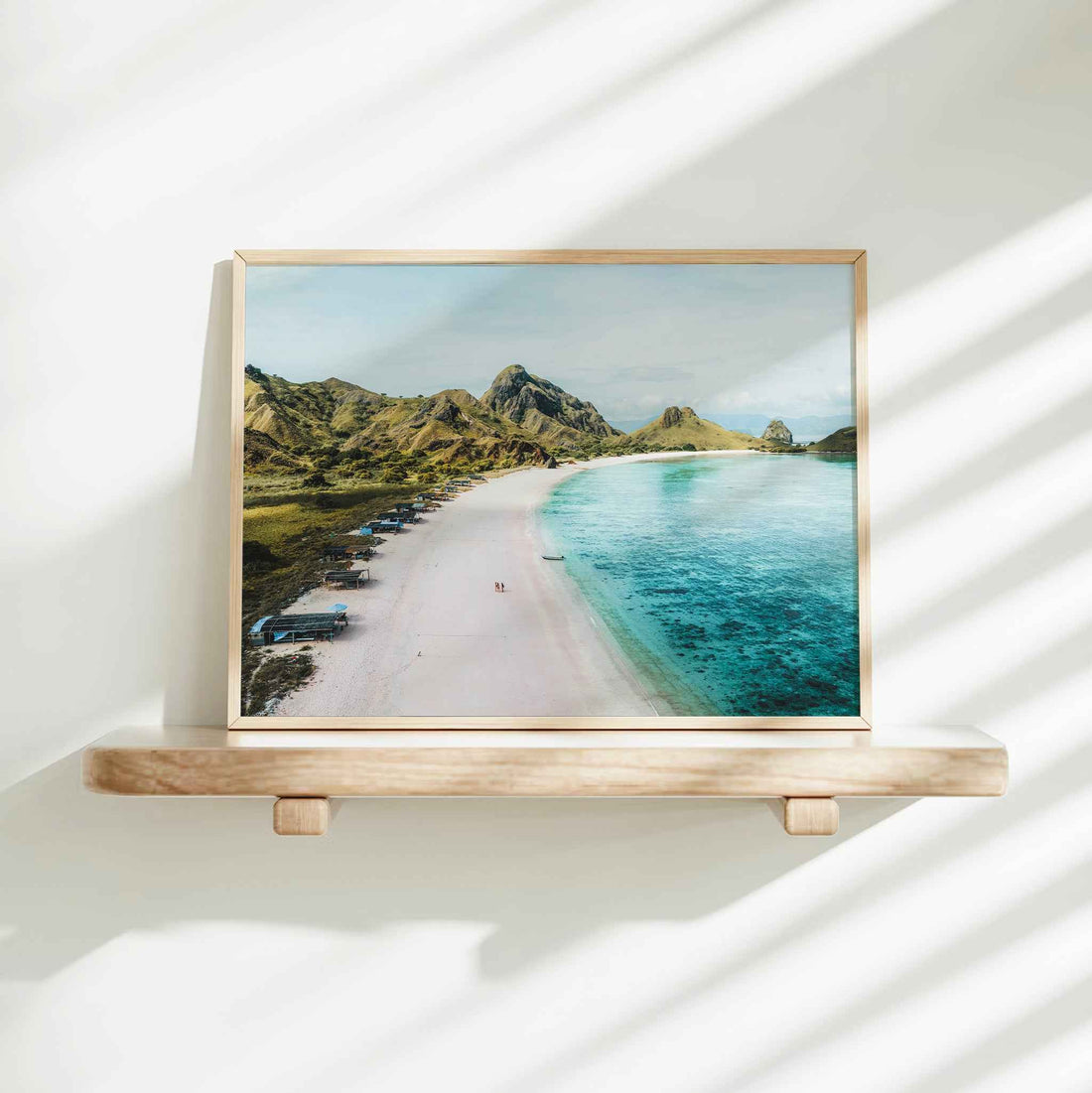 Pink Beach Padar Island Komodo National Park framed wall art print in natural wood frame on white wall shelf with natural shadows