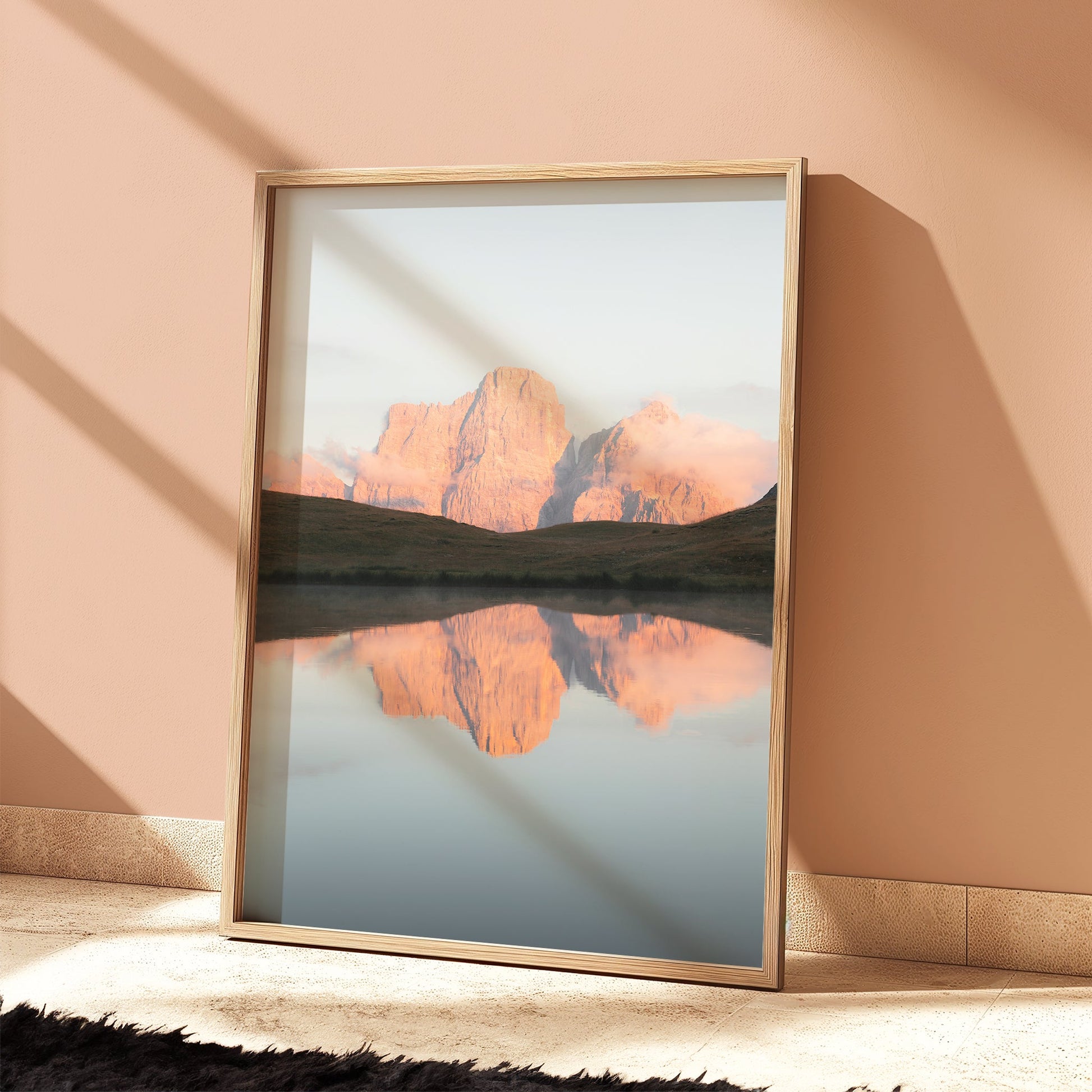 Framed Lago delle Baste wall print in softly lit bedroom