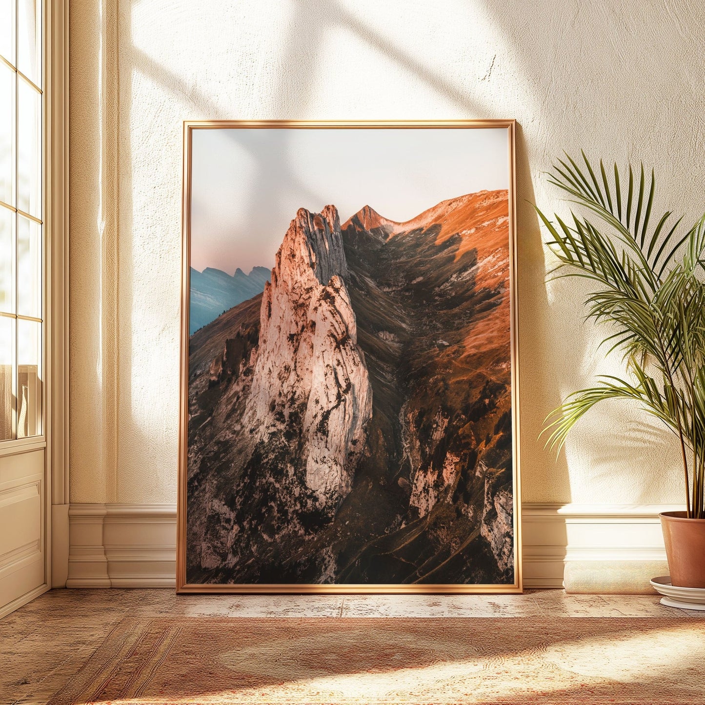 Golden-hour Saxer Lucke landscape, framed in light gold, displayed in a naturally lit corner.