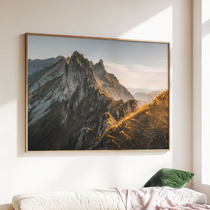 Golden hour on Schafler Mountain Ridge, with dramatic peaks in Appenzell, Switzerland.