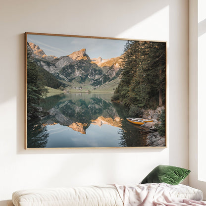 Sunset view of Seealpsee lake in Appenzell, Switzerland, surrounded by lush trees and golden peaks.