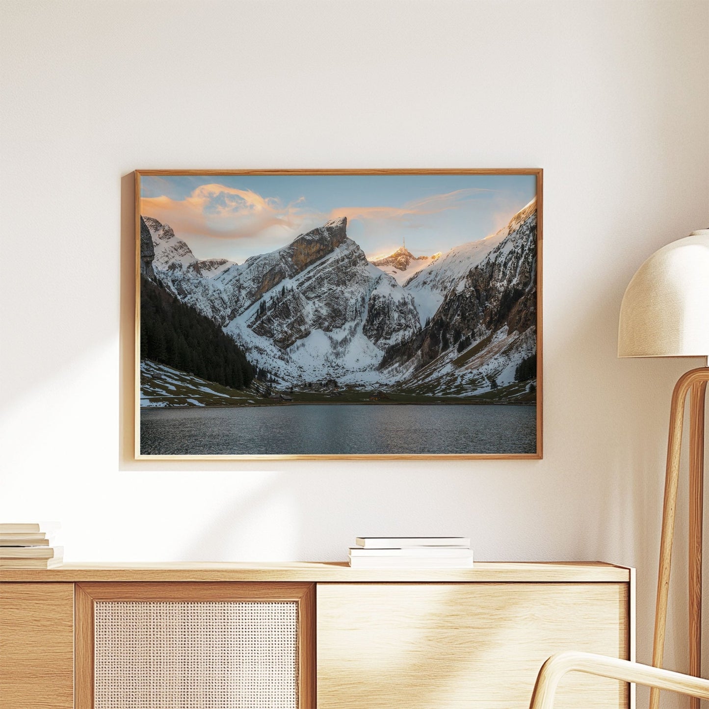 Peaceful Seealpsee landscape with alpine mountains and still lake, blanketed in snow.