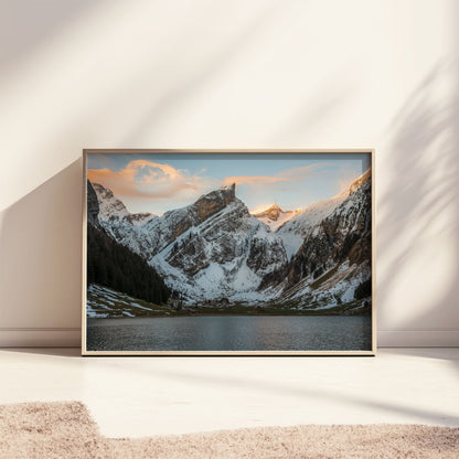 Tranquil snowy scene at Seealpsee, with calm waters and dramatic alpine peaks in Appenzell, Switzerland.