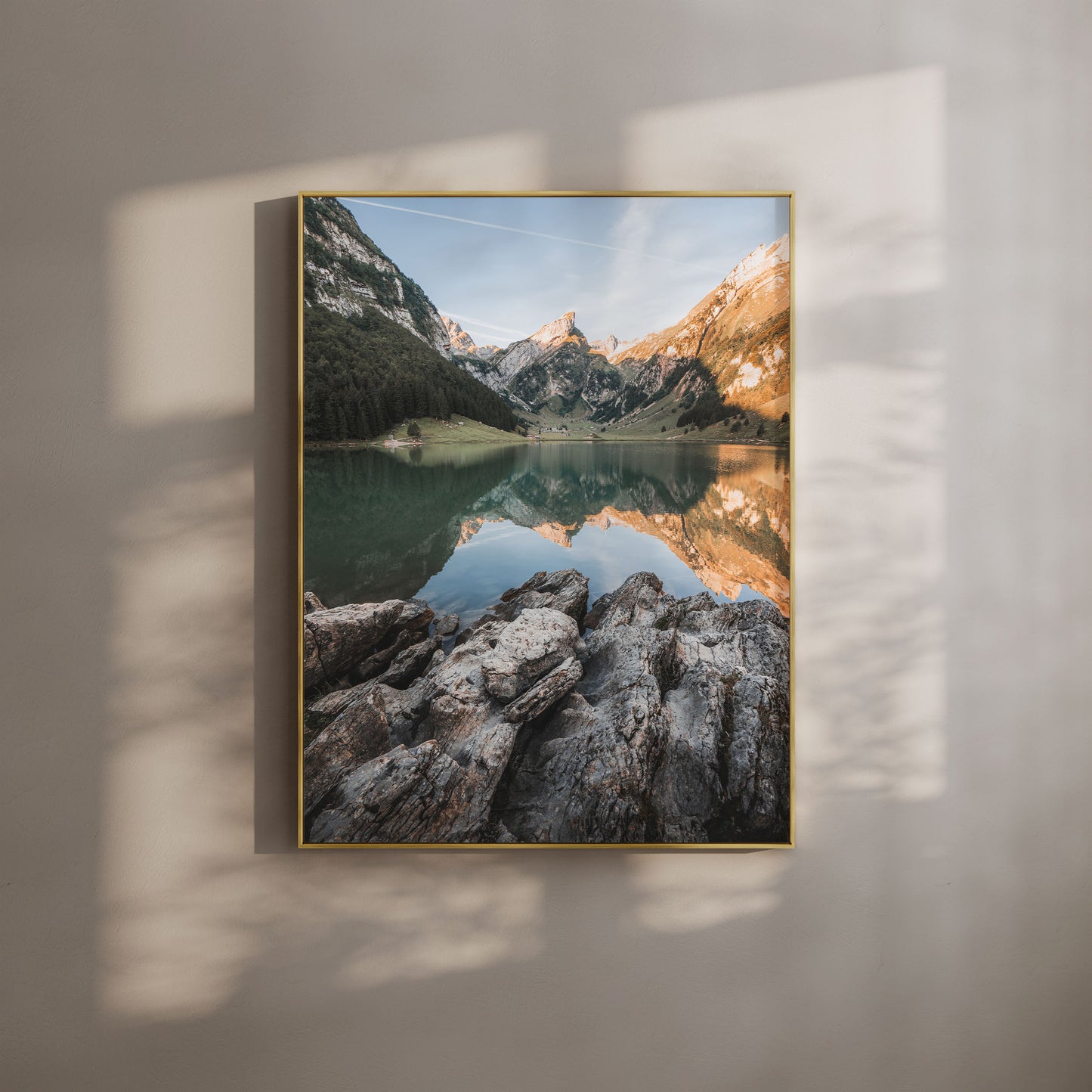 Seealpsee Lake in Switzerland with morning light reflecting the alpine mountains and rocky shoreline, perfect for mountain wall art.