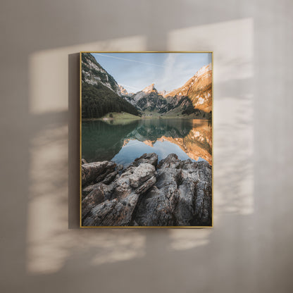 Seealpsee Lake in Switzerland with morning light reflecting the alpine mountains and rocky shoreline, perfect for mountain wall art.