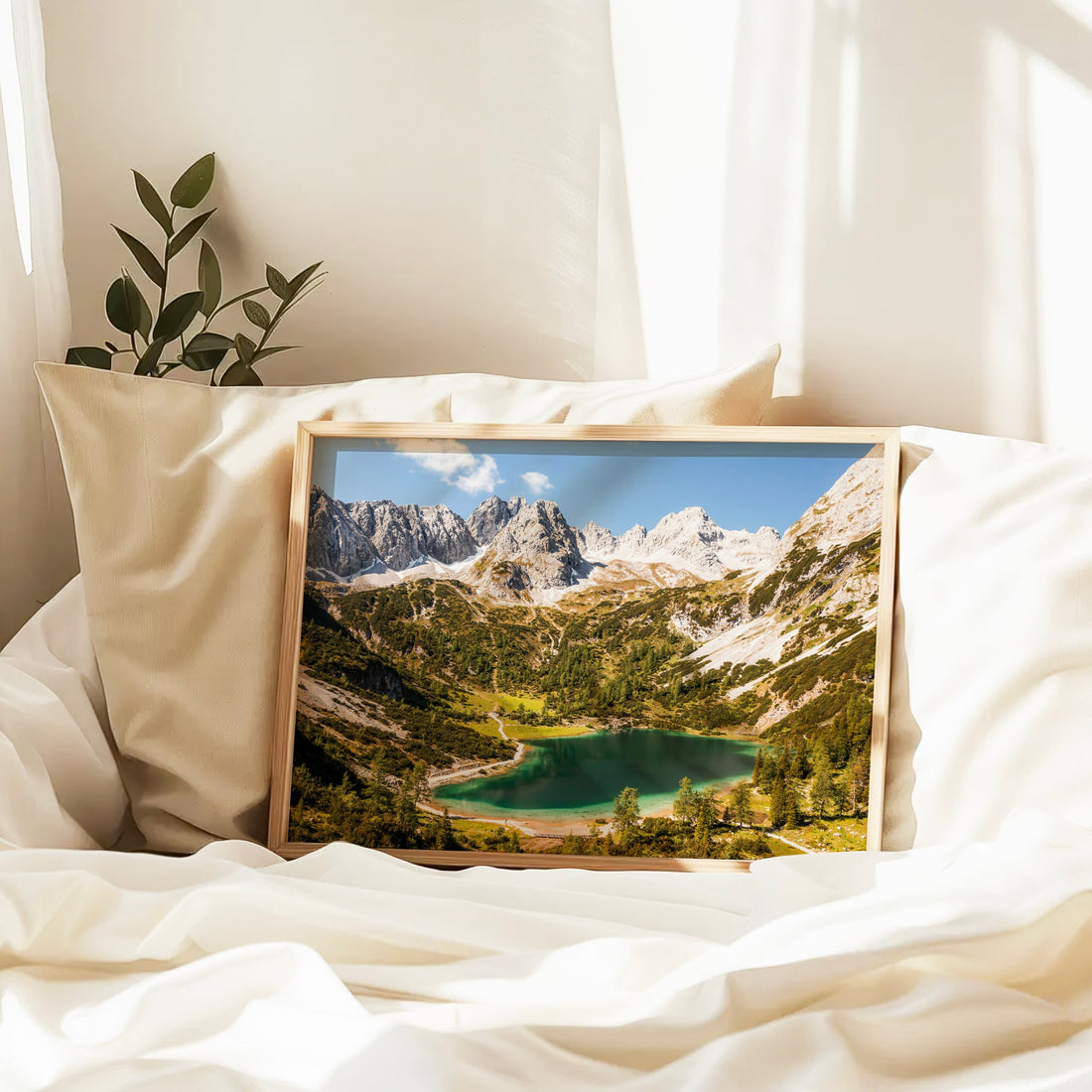 Framed Seebensee lake photography print resting on white bedding