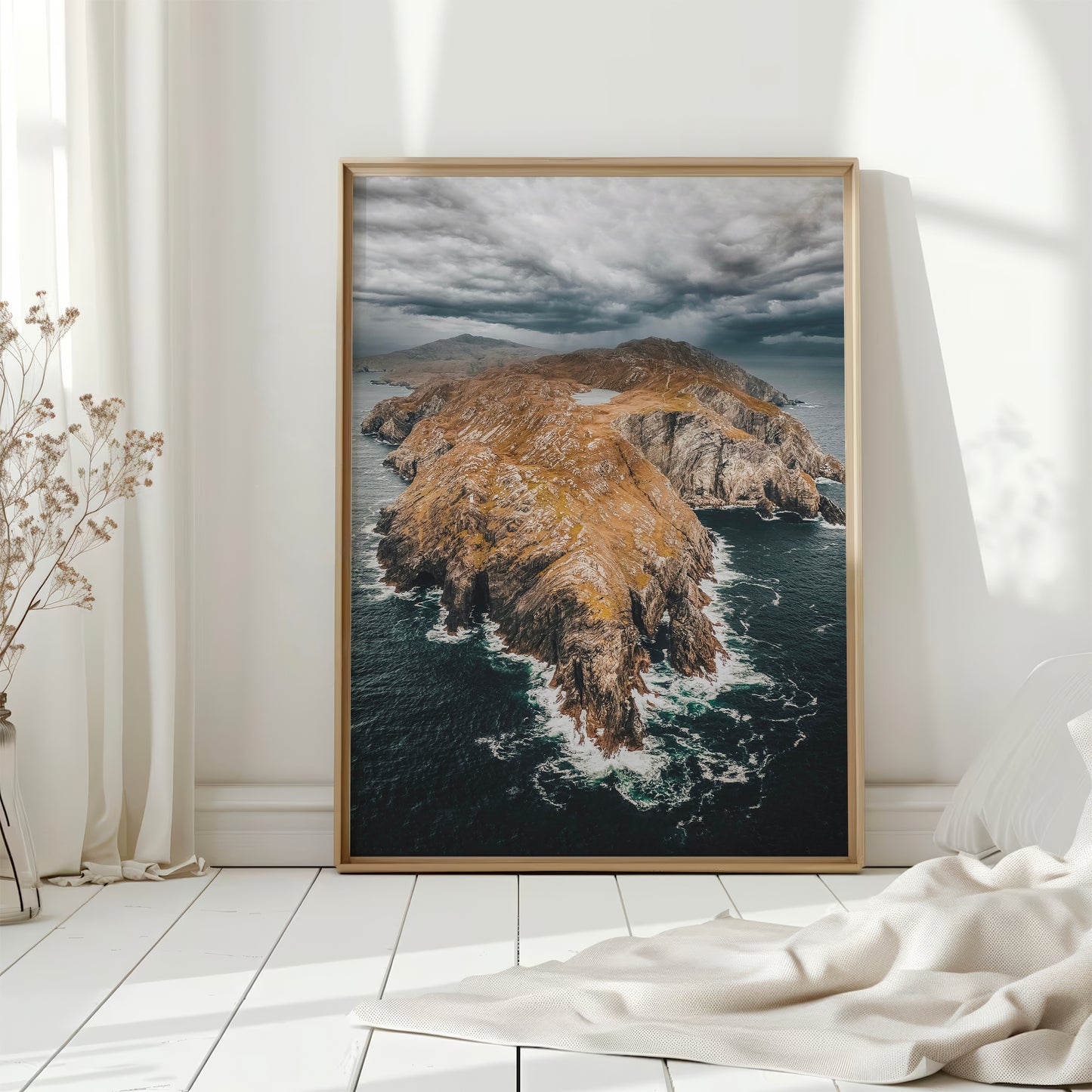 Framed Sheep’s Head print with white curtains and natural light in a clean room.