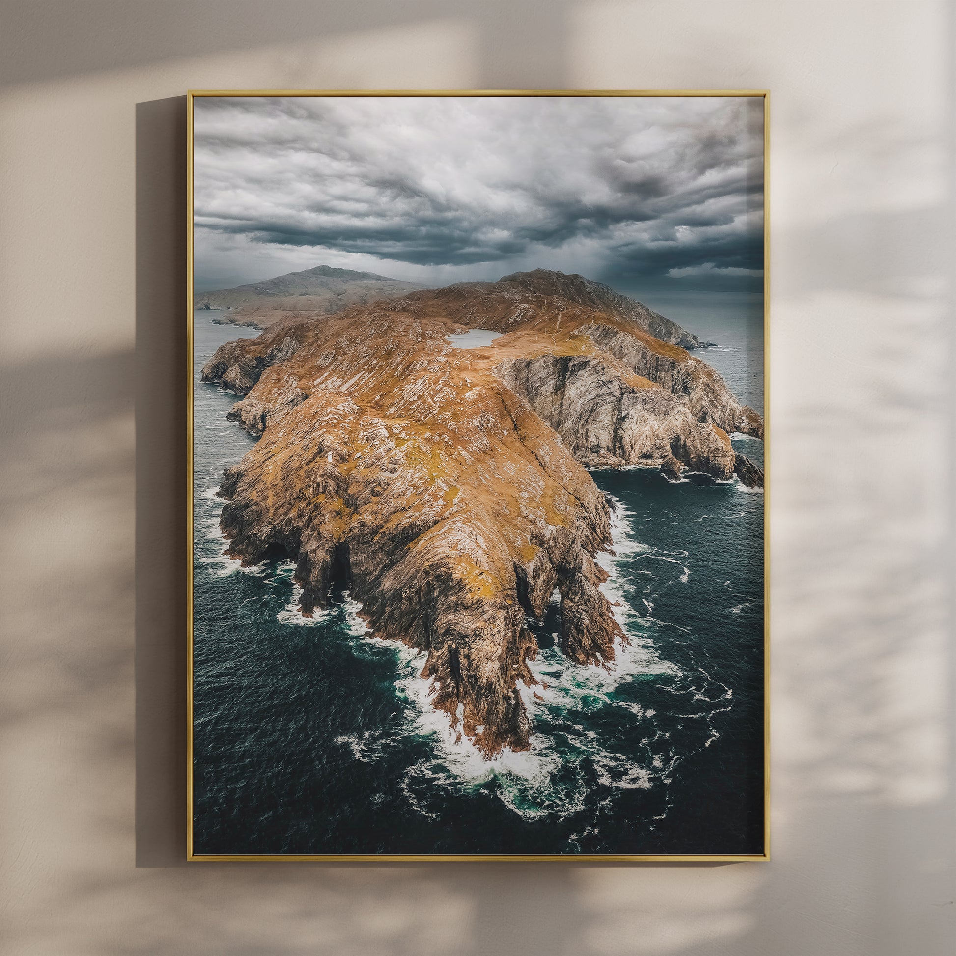Aerial view of Sheep’s Head Peninsula with dramatic clouds and golden cliffs.