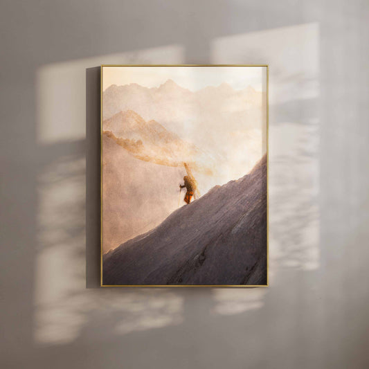 Skier on the Midi Arete carrying skis during sunrise in Chamonix - fine art wall print in gold frame.