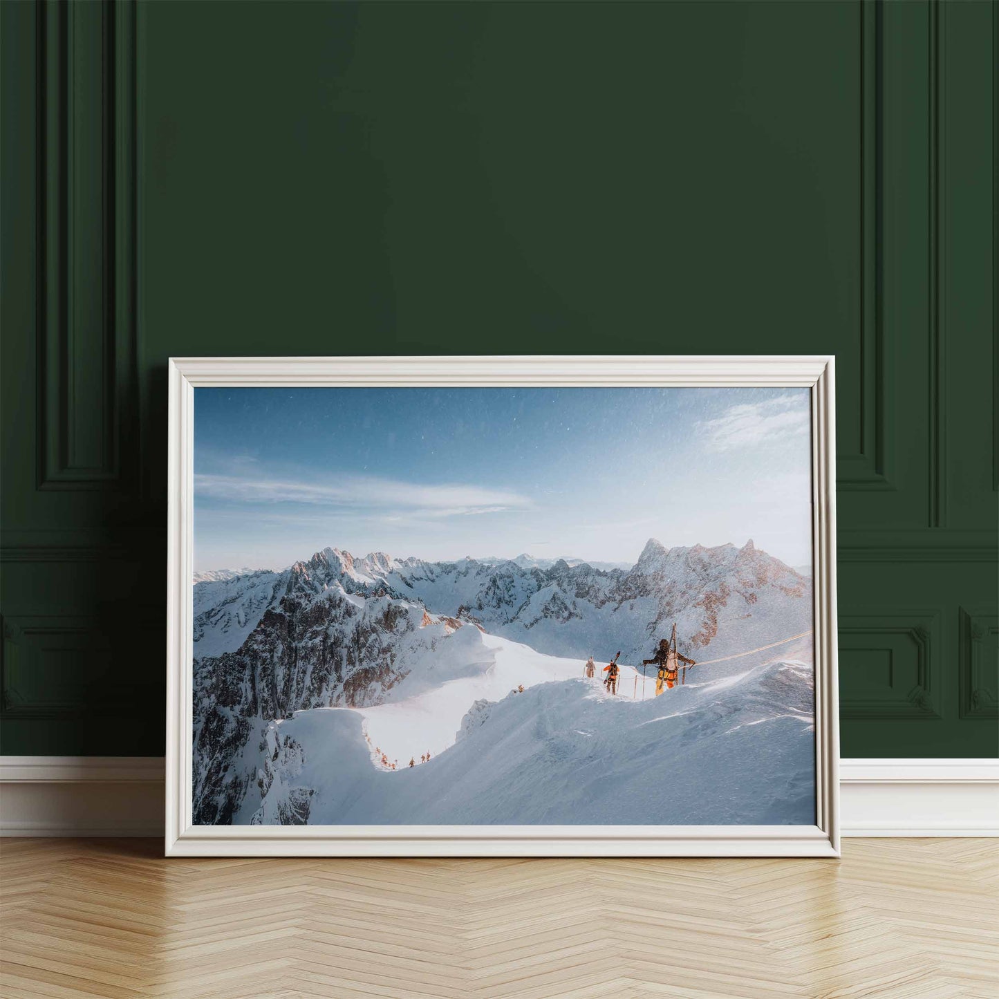 Framed wall art of skiers descending to the Vallée Blanche displayed against a deep green wall