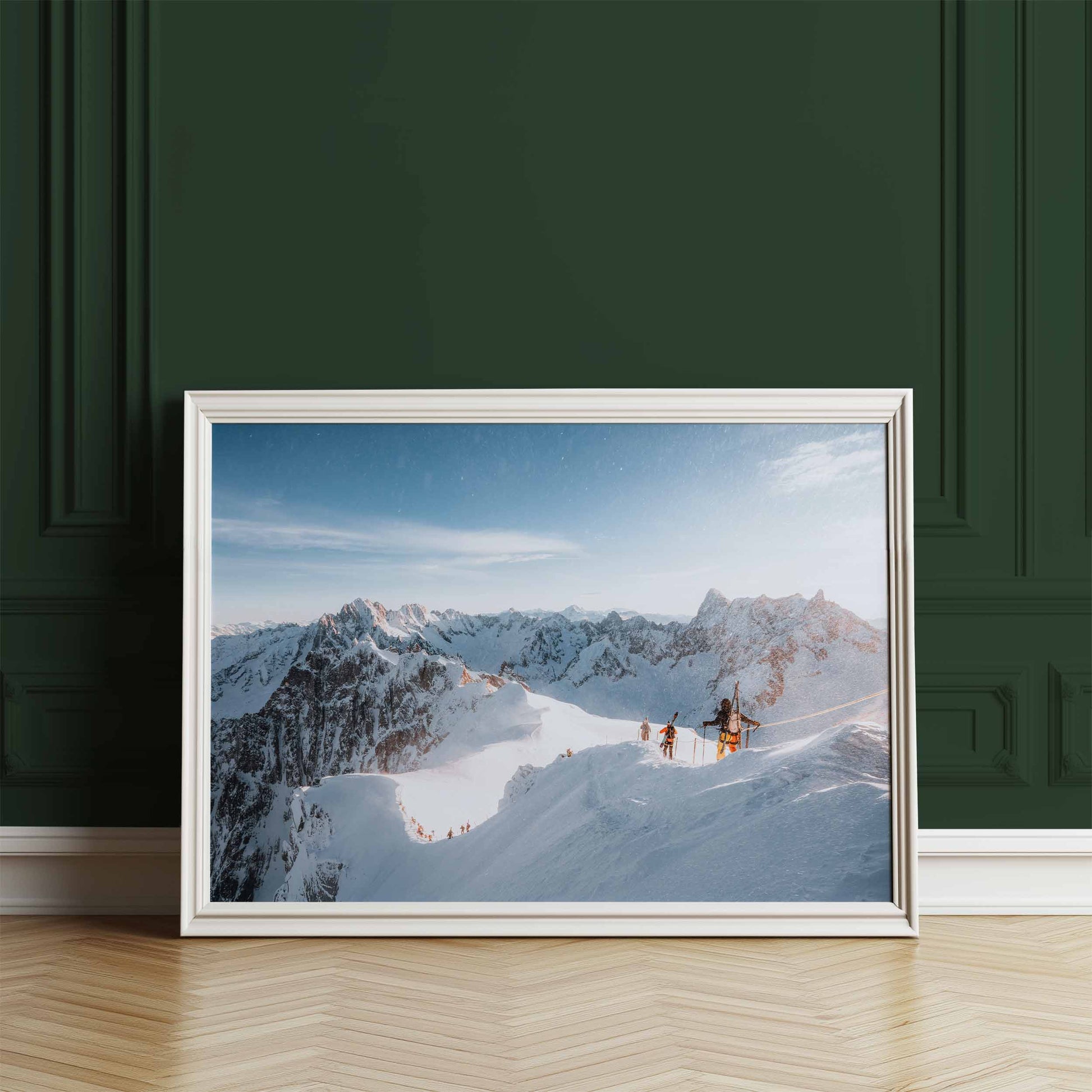 Framed wall art of skiers descending to the Vallée Blanche displayed against a deep green wall