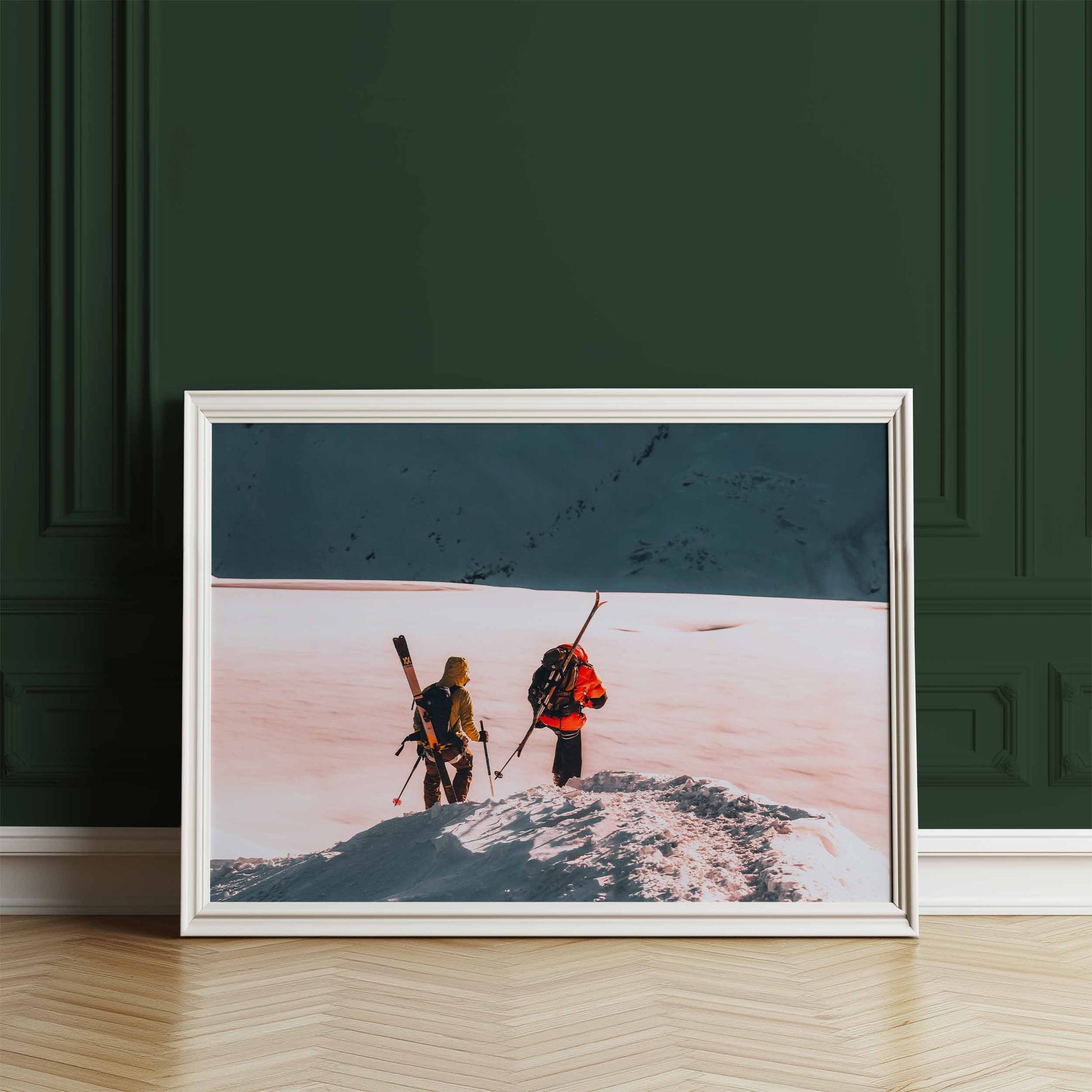 Skiers on the Midi Arête in Chamonix, framed print leaning against a dark green wall.