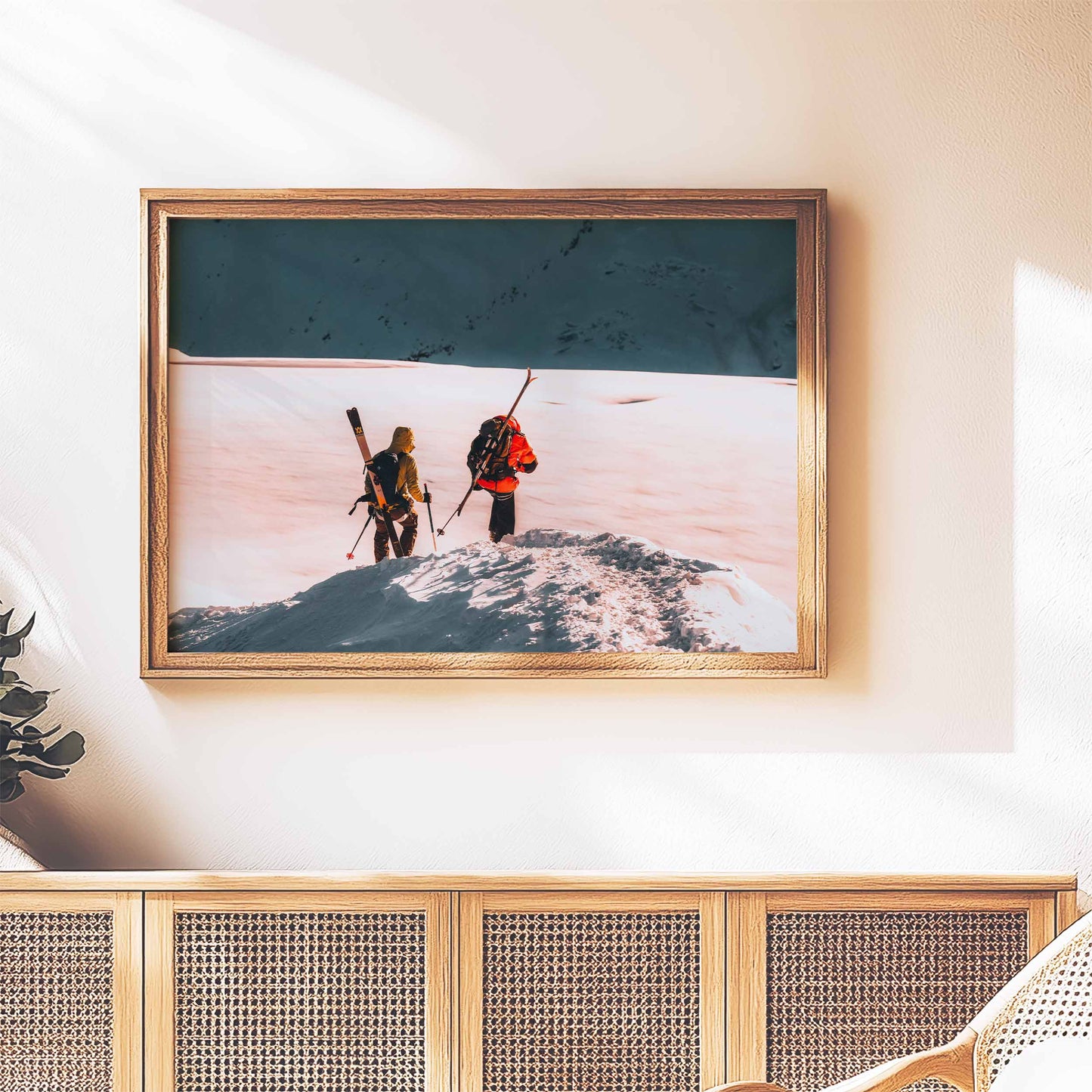 Skiers on the Midi Arête in Chamonix, wall art displayed above a stylish console table.