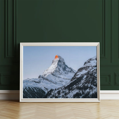 Close-up view of the snowy Matterhorn peak framed against a soft blue sky.