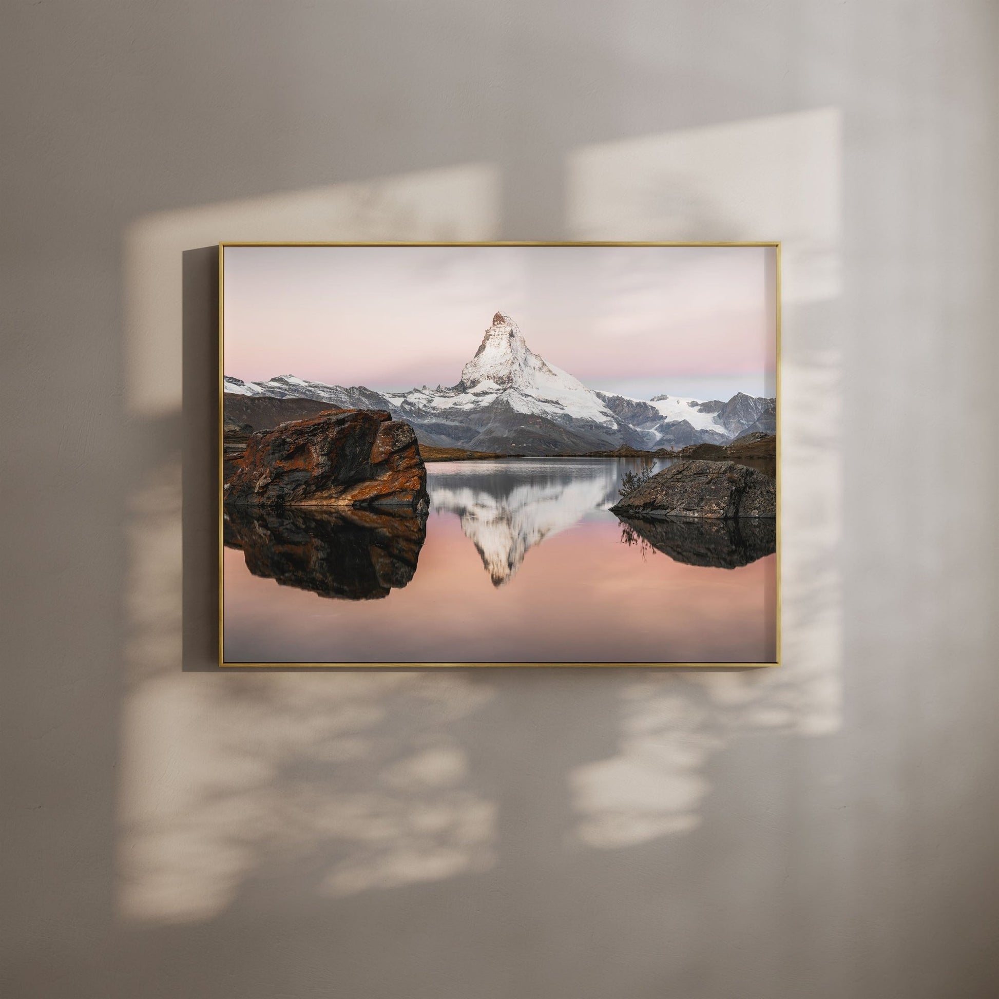 Stellisee lake reflecting the Matterhorn at sunset, surrounded by the Swiss Alps.