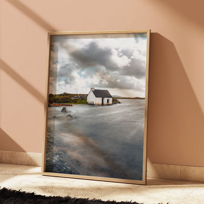 Coastal print of fisherman’s hut with golden and blue tones