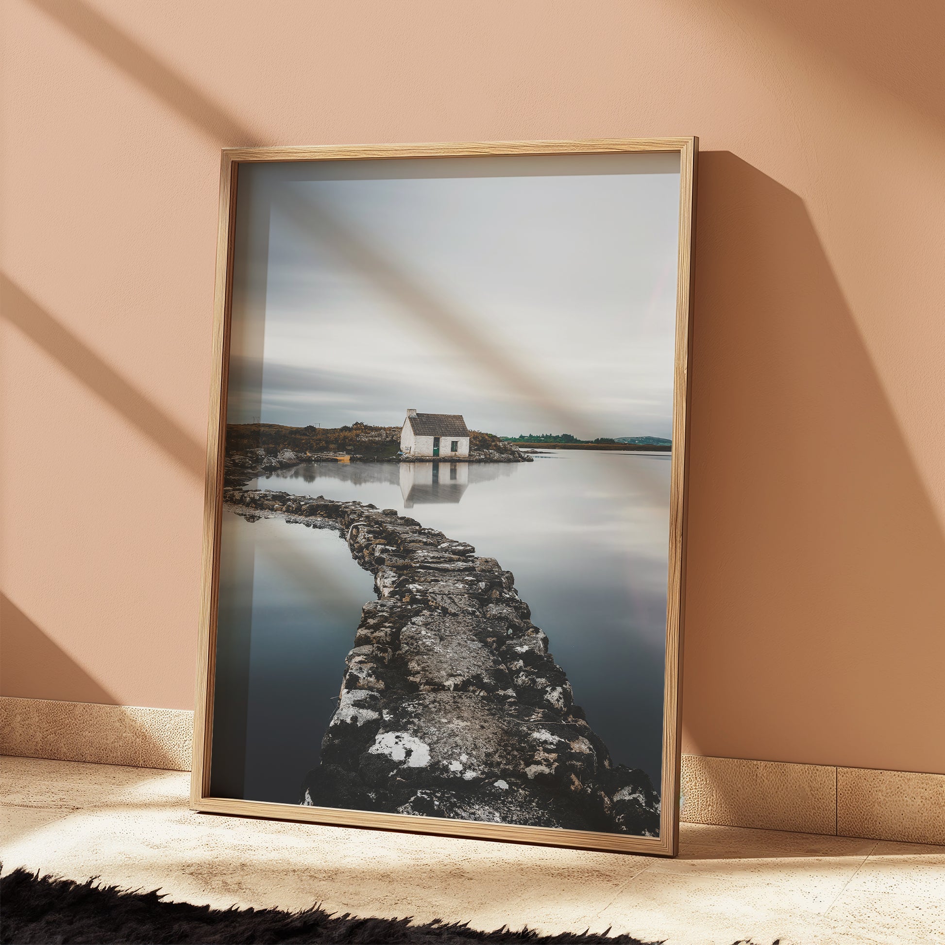 Bothy print against a warm pink wall with dramatic shadows