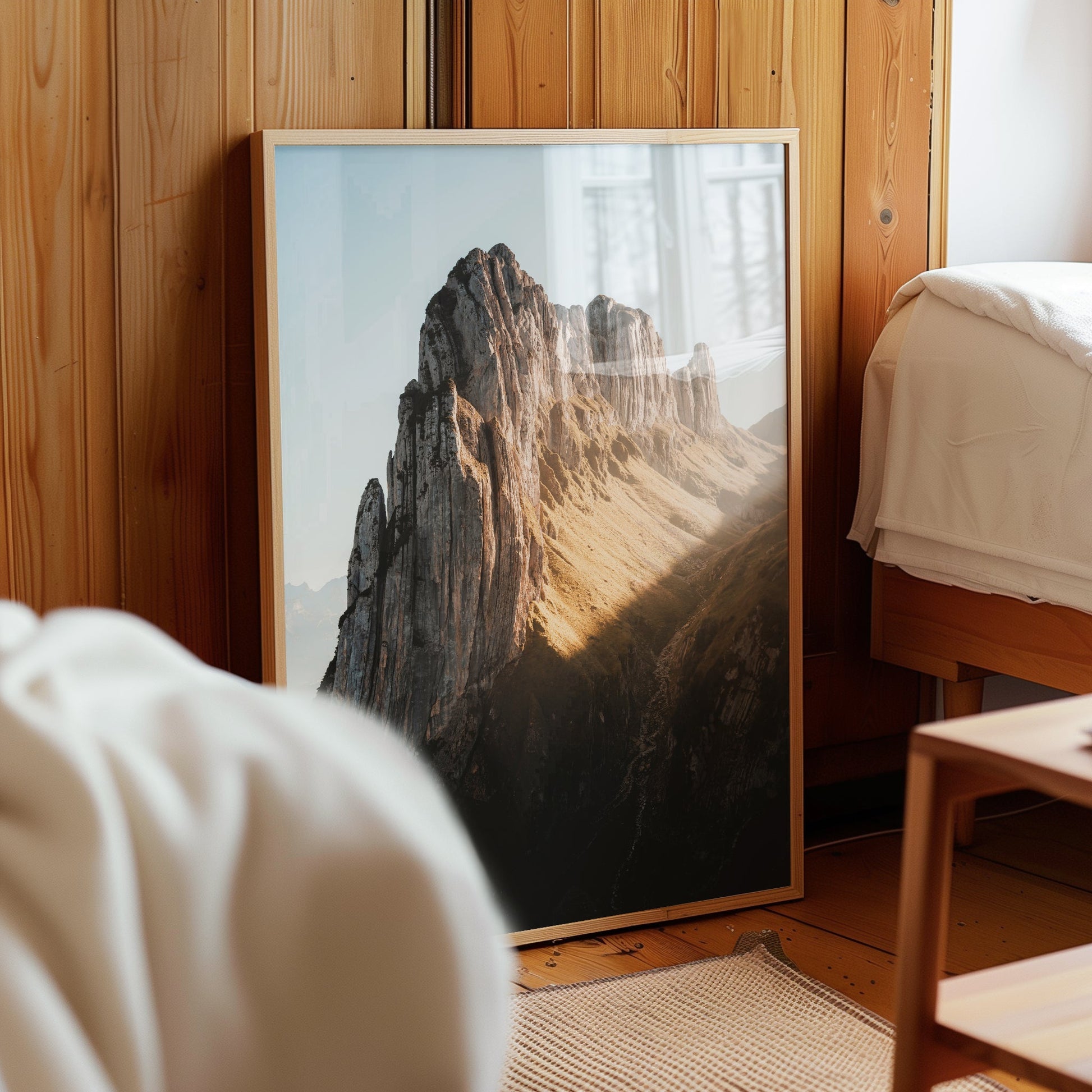 Saxer Lücke alpine print leaned against wooden wall in cosy bedroom.