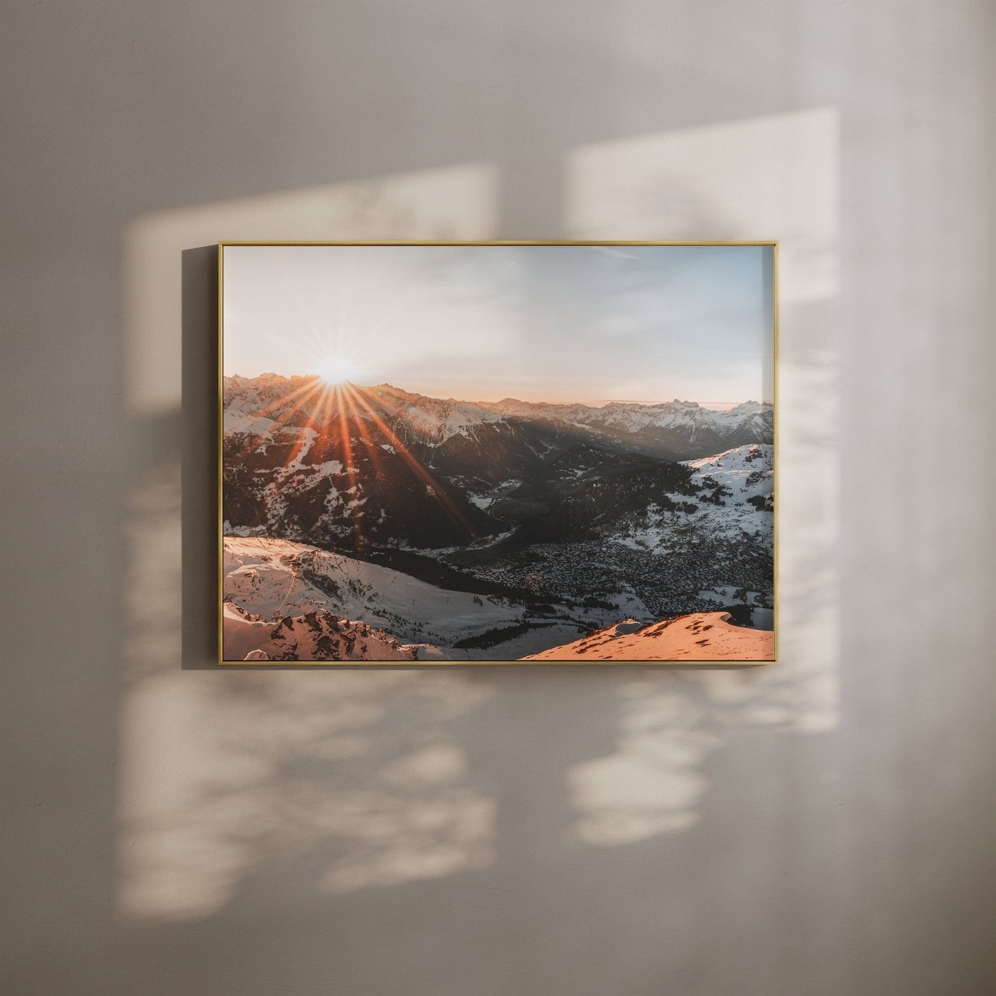 Sunset over the snowy mountains of Verbier, Switzerland, with a warm glow.