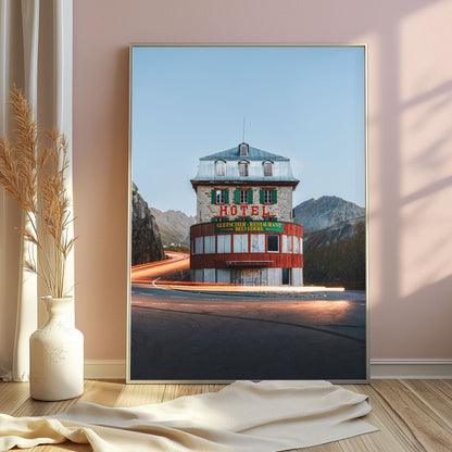 Belvedere Hotel in the Swiss Alps, an alpine road winding around the historic building with mountain landscape in soft light.