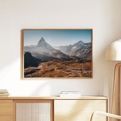 Swiss mountain landscape of Gornergrat and Matterhorn under a clear morning sky, with vibrant autumn tones.