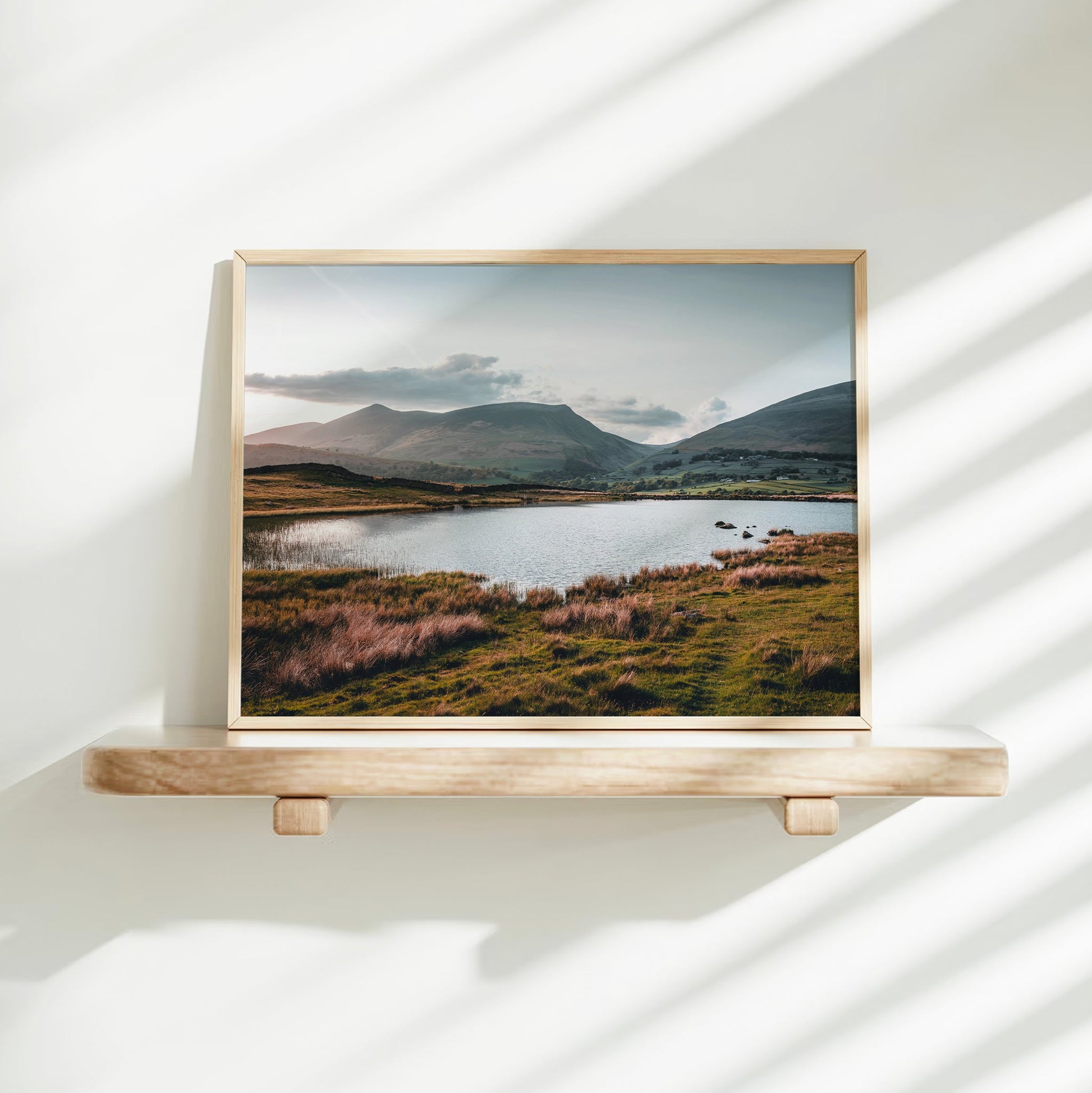 Tewet Tarn photo print with natural window light on white shelf