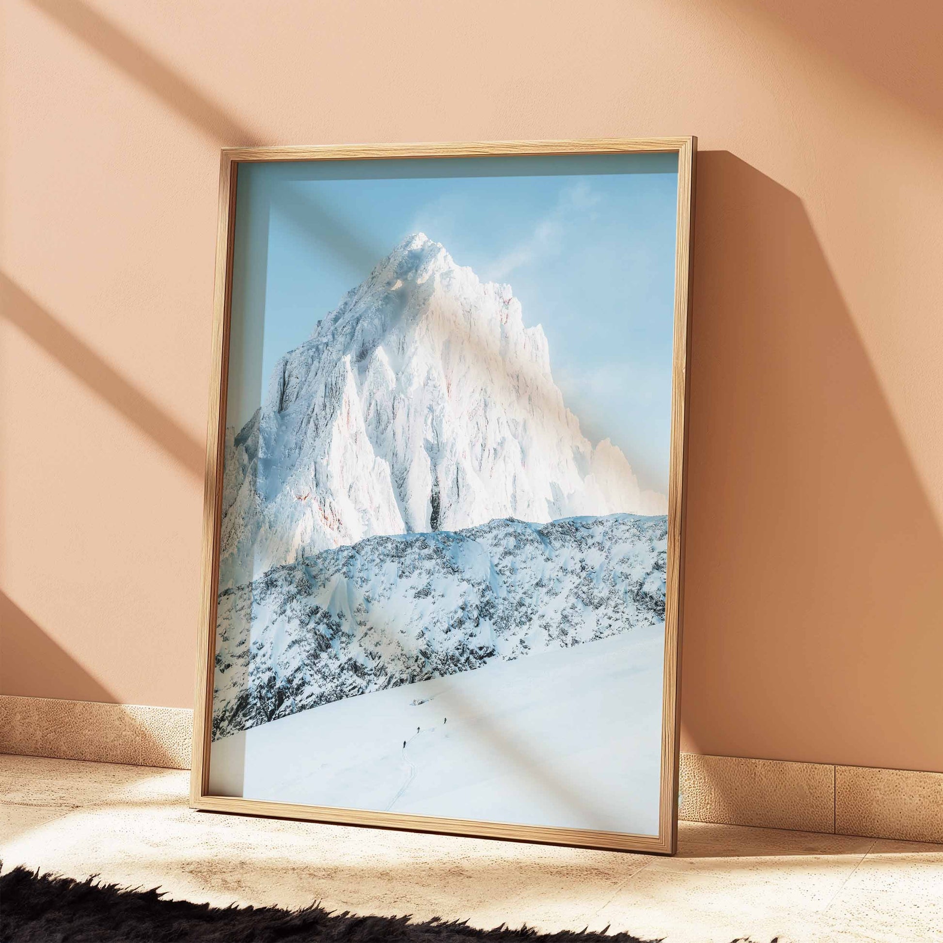 Three ski tourers in Chamonix, snowy mountain backdrop, leaning frame in a cozy corner