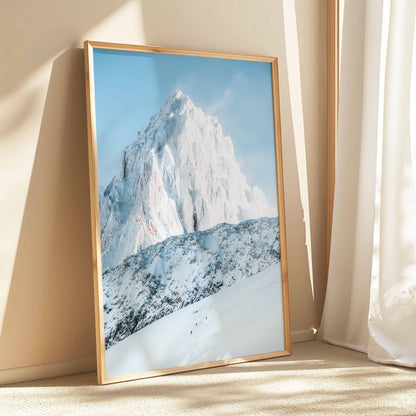 Three ski tourers in Chamonix, snowy mountain backdrop with sunlight streaming through