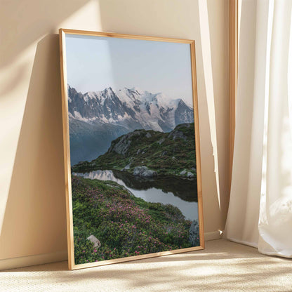 Tranquil Lac de la Flégère reflecting Mont Blanc, surrounded by vibrant alpine wildflowers.