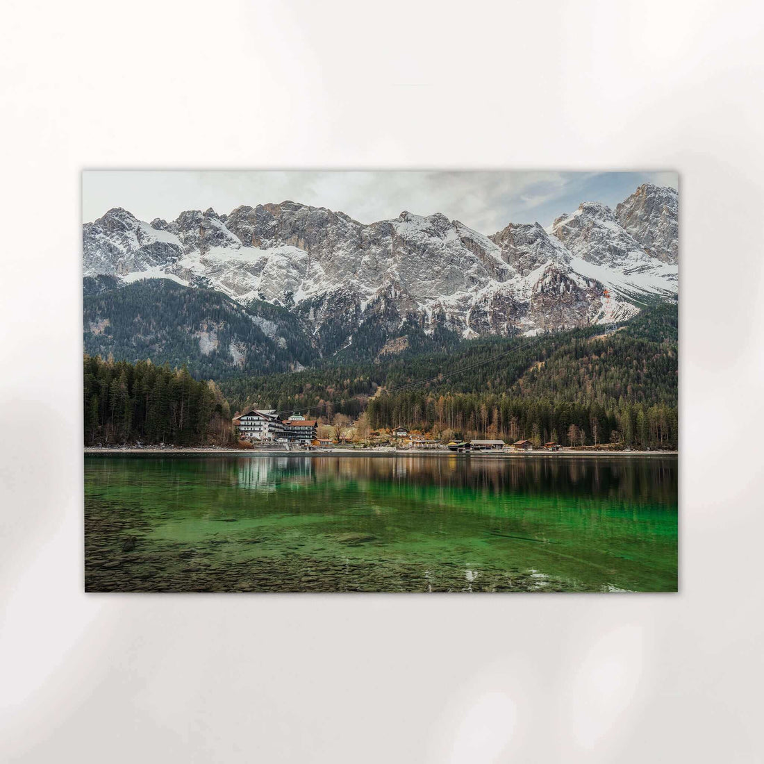 Snow-covered Zugspitze mountain towering above Eibsee in early spring