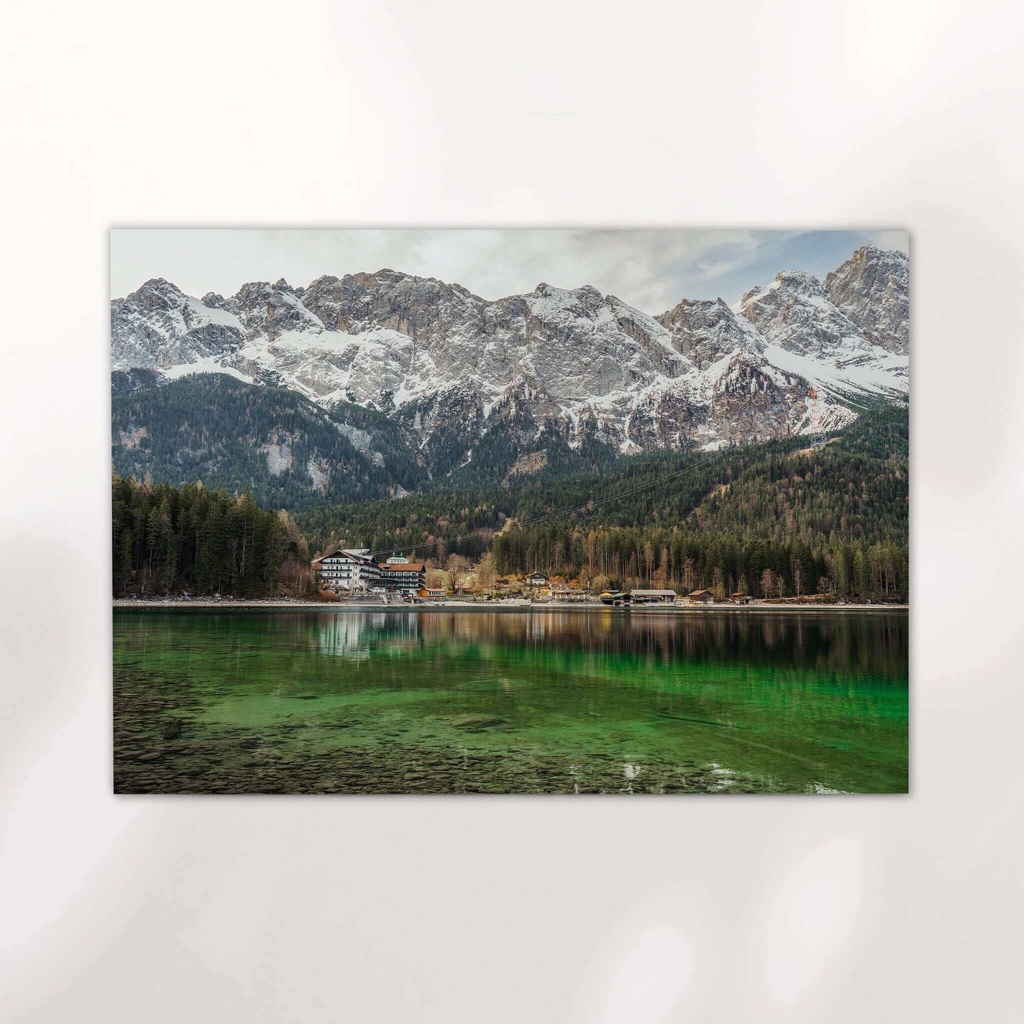Snow-covered Zugspitze mountain towering above Eibsee in early spring